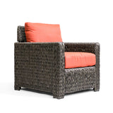 Laguna Point Wicker Outdoor Club Chair, right-hand corner side view showcasing glossy brown wicker and vibrant cushions in Toronto.