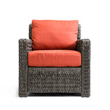Laguna Point Wicker Outdoor Club Chair with glossy brown wicker, wide arms, and vibrant weather-resistant cushions in Toronto.