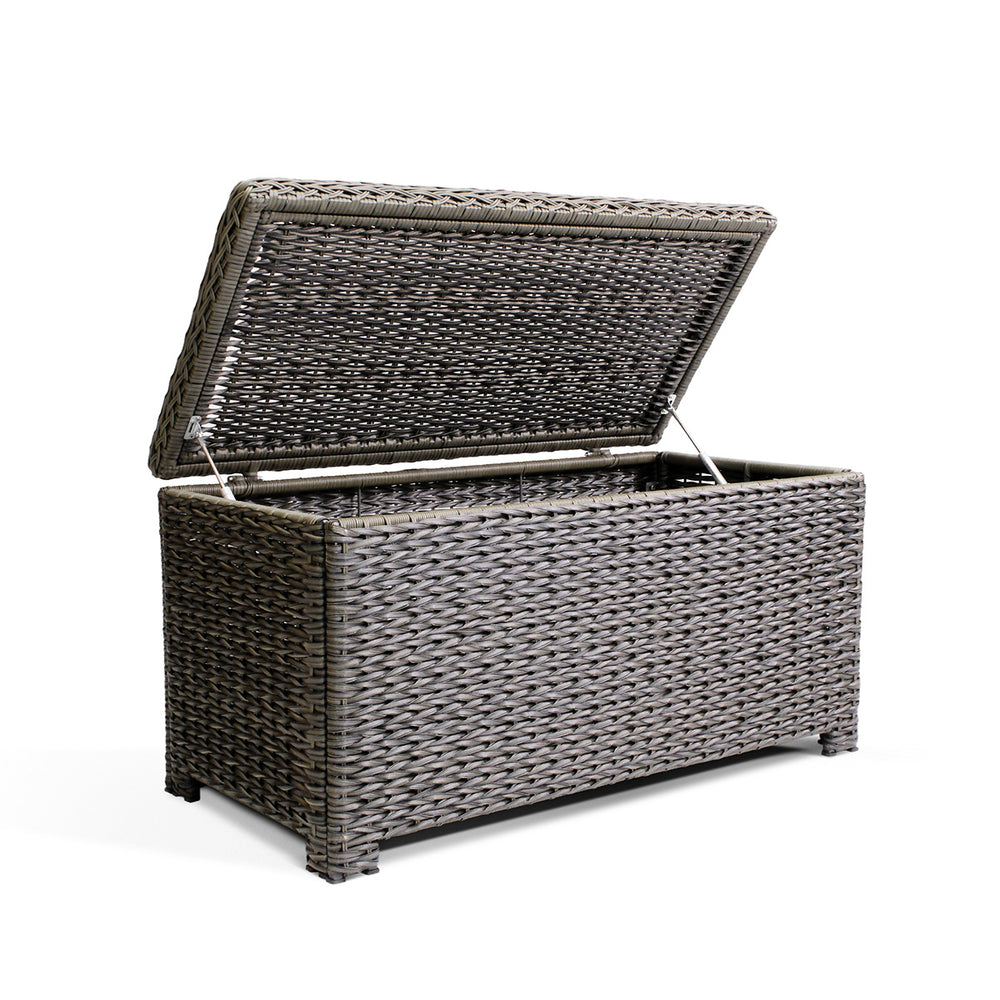 Resilient, all-weather resin wicker coffee table with soft-close hinges, tempered glass top, and ample storage space for blankets and pillows