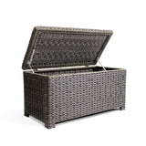 Resilient, all-weather resin wicker coffee table with soft-close hinges, tempered glass top, and ample storage space for blankets and pillows