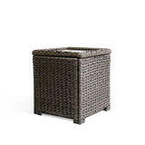 Corner view of the Laguna Point end table with open lid, showcasing the all-weather resin wicker and tempered glass top.