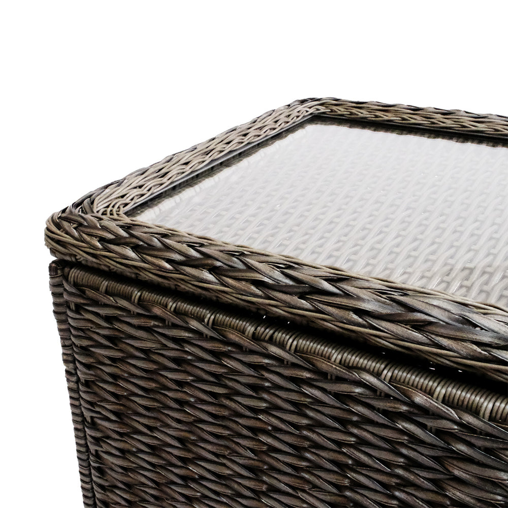 Close-up view of Laguna Point coffee table’s tempered glass top with wicker frame, highlighting the sturdy construction and design.