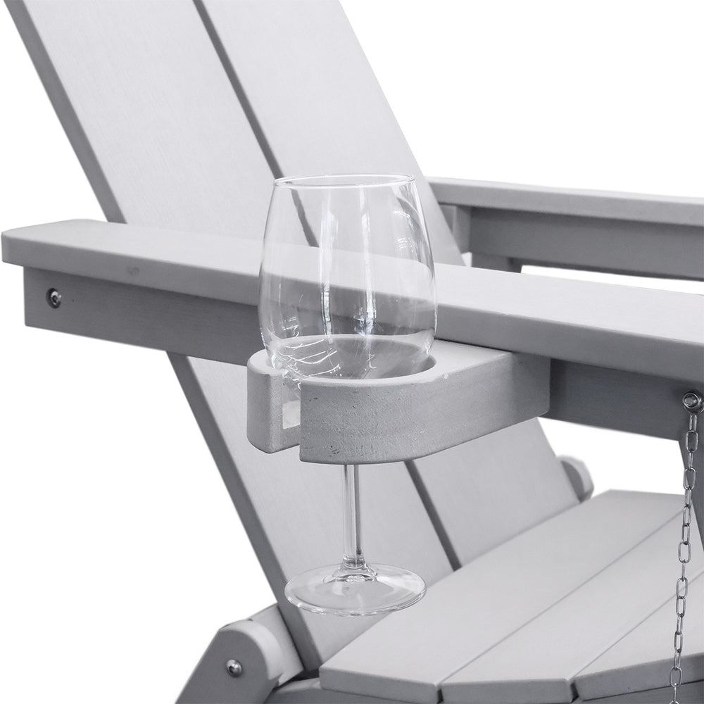 Close-up of the gray Adirondack chair's cupholder with a white glass, showcasing the detailed design.