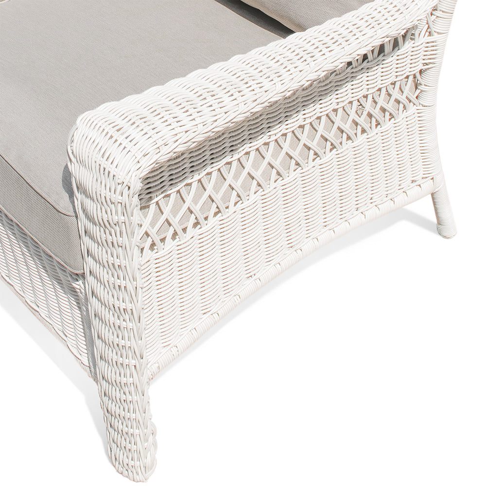 Close-up of the left armrest of Park Meadows Outdoor Chair, highlighting the detailed white cream wicker and plush cushion.