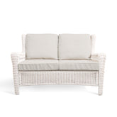 Park Meadows Wicker Outdoor Loveseat with plush cushions and diamond weave details, outdoor setting in Oakville, ON.