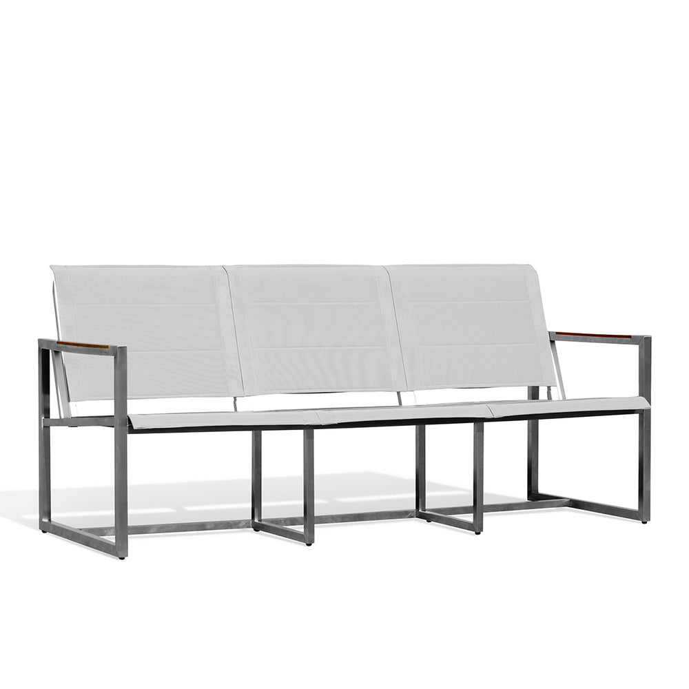 Side angle view of Pine Stainless Steel & Teak Outdoor Sling Sofa with slim profile, teak accents, and ergonomic Textilene seating, Oakville, ON.