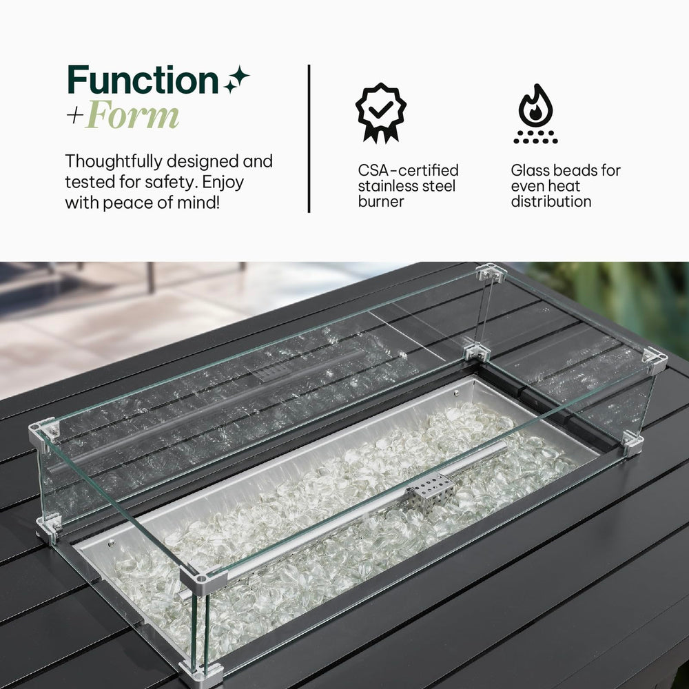 Close-up view of the Aluminum Propane 48" Rectangle Outdoor Fire Pit Table featuring heat-retaining glass beads and a sturdy glass windguard for a steady flame, Oakville, ON.