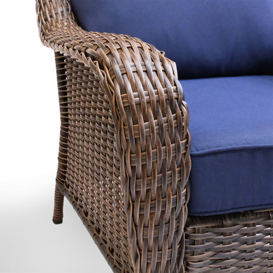 Close-up view of the armrest on the Cambridge sectional, showcasing the detailed wicker weave and plush, weather-resistant cushion.