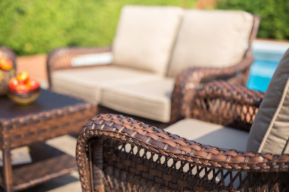 Close-up left-side view of the Colossal 4-Piece Wicker Conversational Set with Sunbrella® Cushions, set beside a pool, showcasing its elegant design, Creditview.