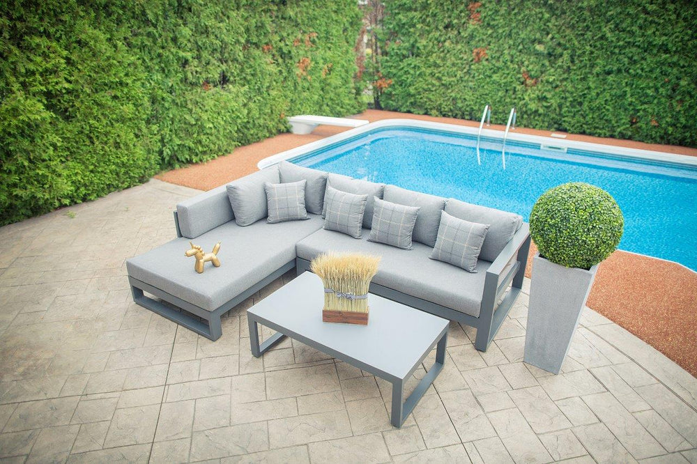 A cozy sectional set with teak wood accents, perfect for outdoor lounging near the pool, offering comfort and style in a compact design.